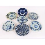 Six various 18th Century Delft plates and shallow dishes; and a faience ware shaped serving dish,