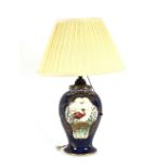 A Booth's silicone china reading lamp, decorated with panels of exotic birds on a Royal blue