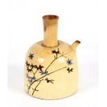 An unusual oriental pottery flask, decorated with blossom and calligraphy, having side spout and