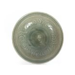 A 17th Century South East Asian celadon glazed bowl, decorated to the interior with flowerhead and