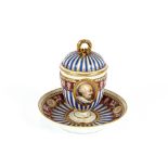 A German porcelain chocolate cup and cover, with classical decoration, inscribed "Henri IV"; a