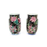 A pair of large Chinese baluster vases, decorated with flowers on a black ground, 31cm high