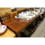 An oak dining table with set of eight slat back ch