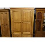 A large stripped pine double wardrobe fitted two d