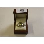 A silver and green stone set dress ring