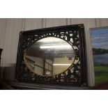 An ornate oval wall mirror