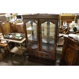 A reproduction mahogany and glazed cabinet fitted