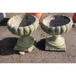 A pair of concrete garden urns