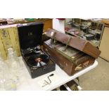 An HMV table top gramophone; and a suitcase of alb