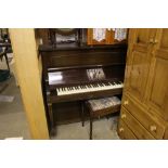 A Cramer of London mahogany upright piano with sto