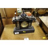 A Victorian style black slate mantel clock of arch