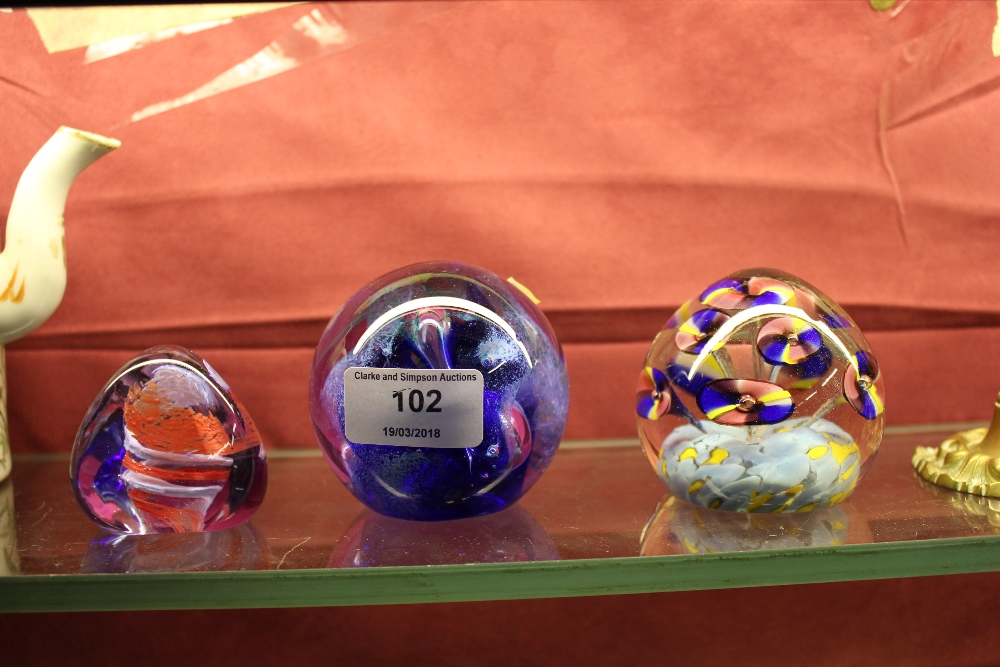 Two Caithness glass paperweights; and one other pa
