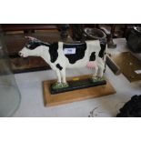 A cast iron door stop in the form of a cow