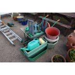 A galvansied wheel barrow and contents of various