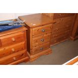 A pine bedside chest fitted three drawers