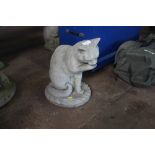 A concrete garden ornament in the form of a cat