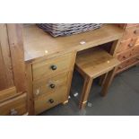 An oak desk and stool fitted three drawers and a stool