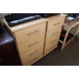 A pair of beech effect bedside chests fitted four drawers