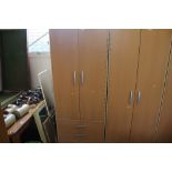 A modern pine effect two door wardrobe fitted thre