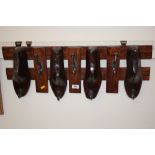 A coat rack decorated with shoe lasts