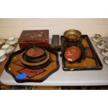 A collection of various lacquered trays, bowls, an