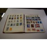 Collection of world stamps in red album, countries