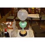 An Art Deco oil lamp with etched glass shade