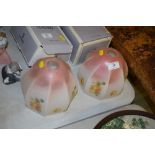 A pair of Art Deco floral decorated glass light sh