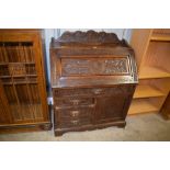 A Victorian carved oak four drawer bureau