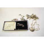 A silver charm bracelet hung with various charms;