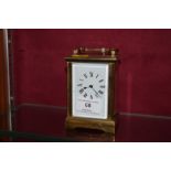 A brass cased carriage clock with key