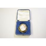 A carved cameo brooch contained in pinchbeck mount