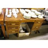 An oak five drawer writing desk