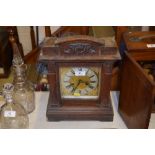 An early 20th Century oak two hole mantel clock