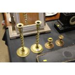 A pair of brass open twist candlesticks; and a pai