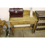 A stripped pine two tier washstand / side table