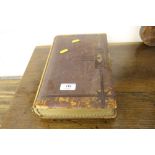 A leather and brass bound photograph album with so