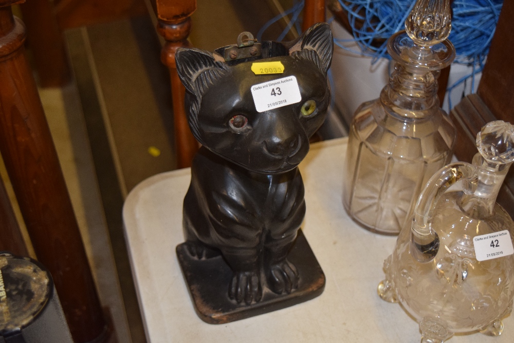 A carved wooden brush holder in the form of a cat,