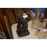 A carved wooden brush holder in the form of a cat,