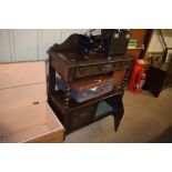 A Victorian carved oak two tier buffet with face m