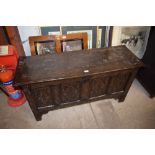 An antique carved oak coffer