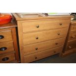 A pine effect chest fitted four drawers