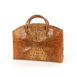 A large crocodile skin vintage handbag