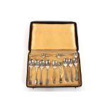 A case containing four matching silver teaspoons;