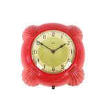 A red Bakelite Metamec wall clock