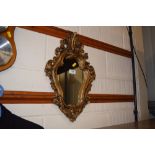 An ornate gilt framed mirror