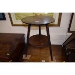 A mahogany circular top two tier table