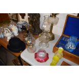 Two clear glass oil lamps; and a Geschutzt glass s