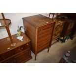 An Edwardian mahogany music cabinet with lift up t