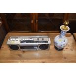 A Panasonic radio cassette player and a china tabl